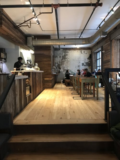 Elixr Coffee Shop: industrial room with a coffee bar on the left.
