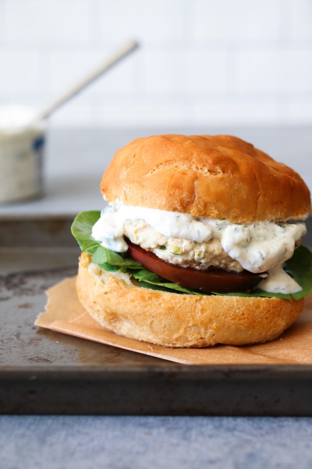 Easy Greek chicken burgers stuffed with lemon, garlic, oregano, rosemary, and feta.