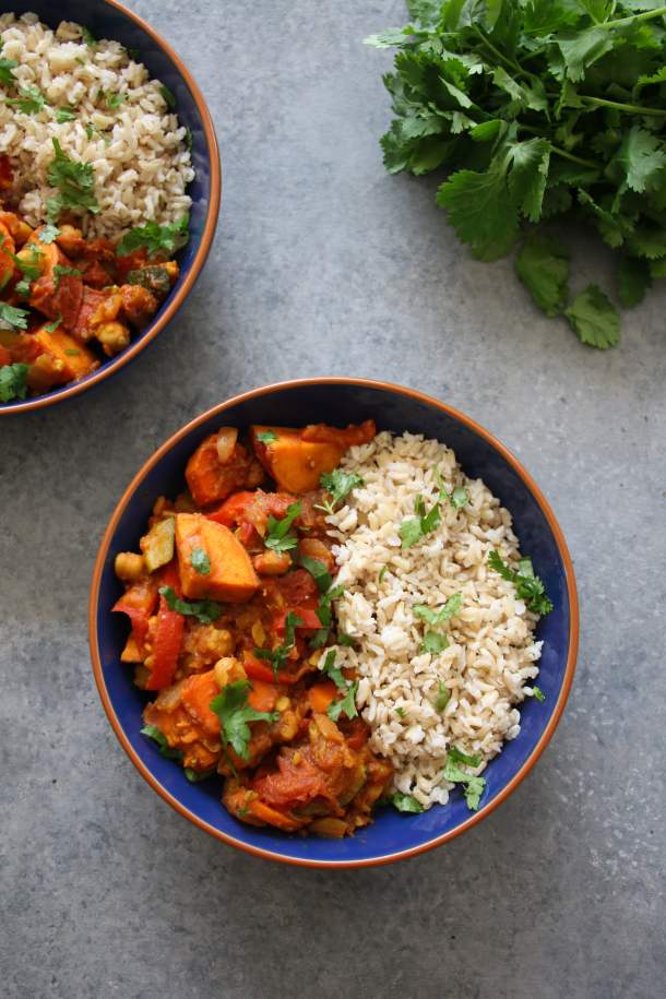 Vegan Moroccan tagine made with 6 veggies, dried apricots, and chickpeas.