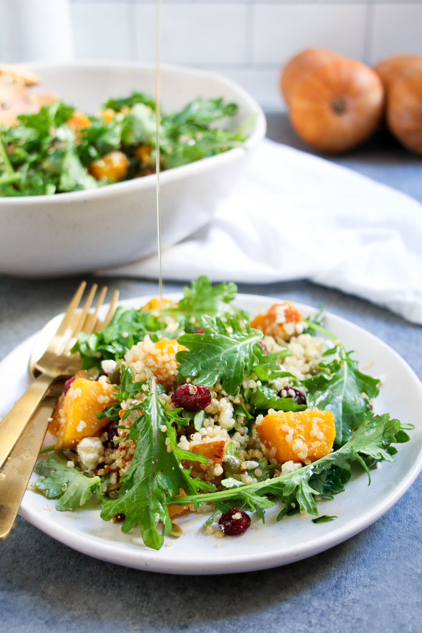 Pumpkin-cranberry salad on a white plate on a gray background