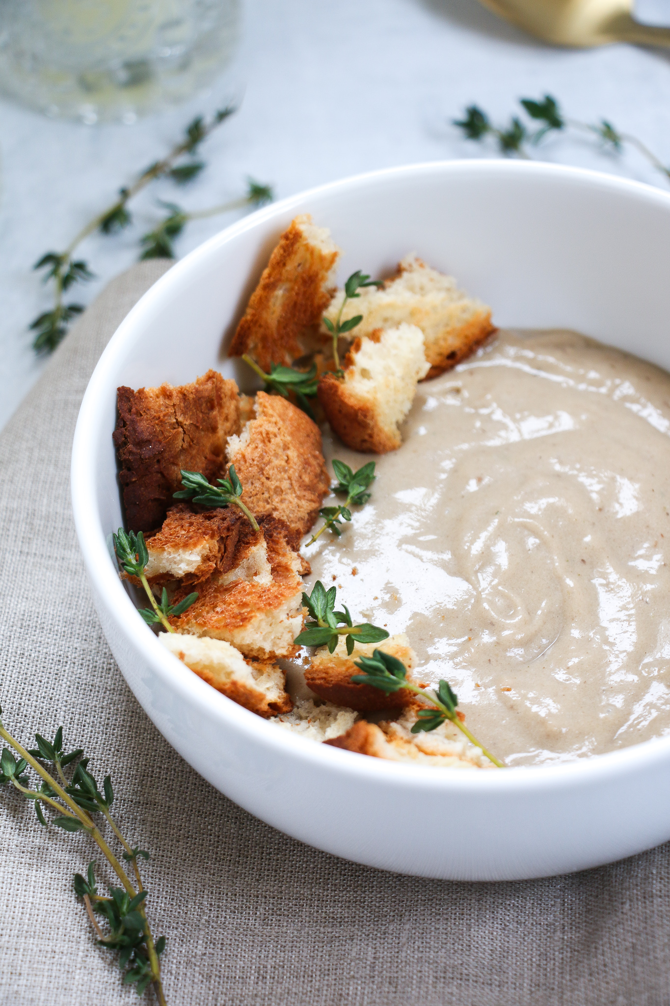 Close-up of vegan cream of mushroom soup in a white bowl.