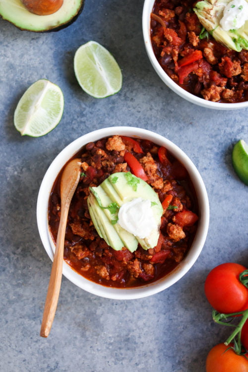 Two bowls of easy turkey-black bean chili on a gray background